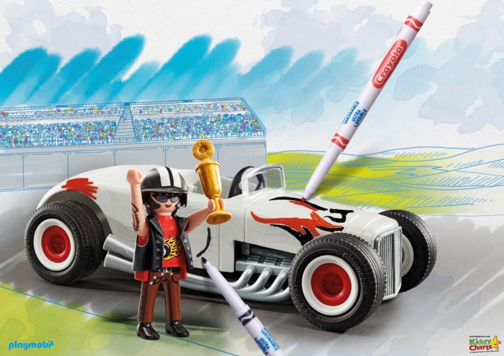 A Playmobil figure celebrates with a trophy next to a white toy race car with red detailing, while drawing on the scene with a crayon.