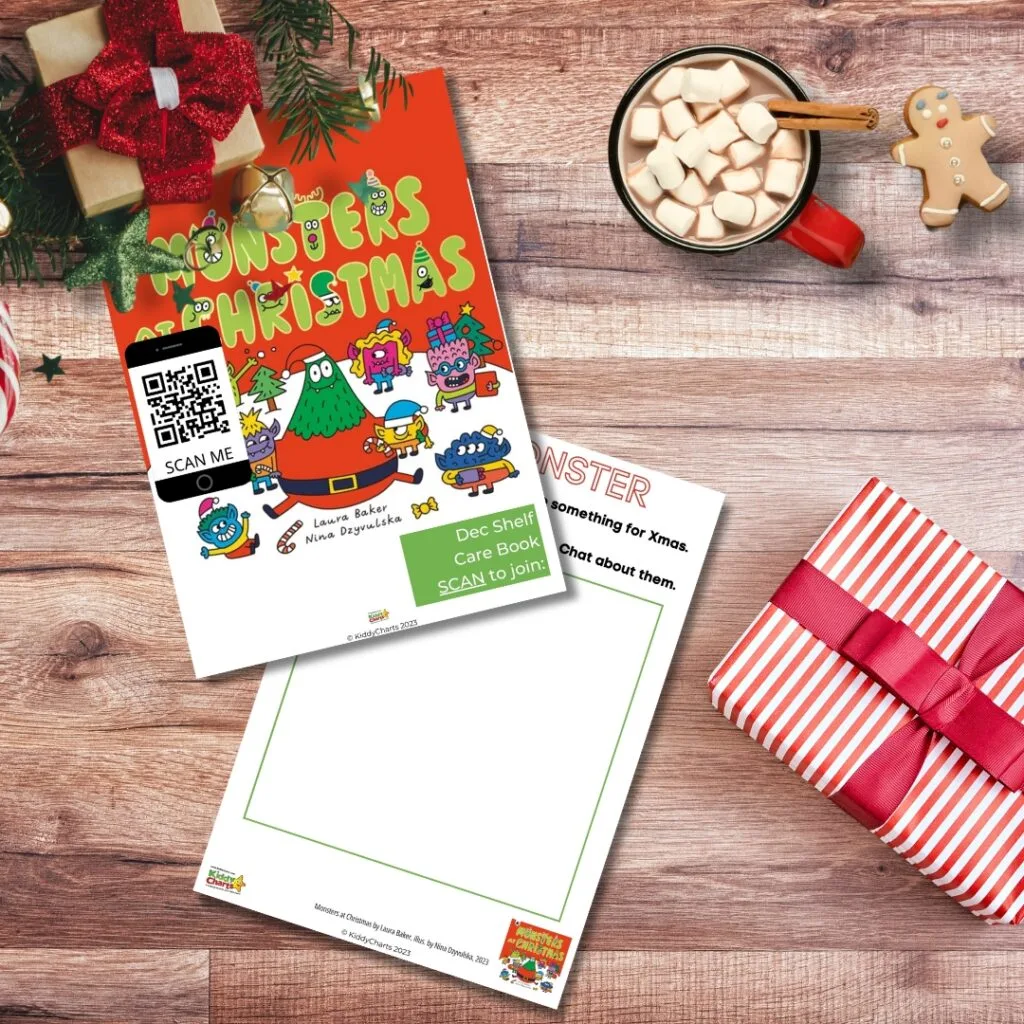 A festive flyer titled "MONSTERS CHRISTMAS" with QR code lies beside a hot chocolate mug, gingerbread cookie, and a striped gift box on a wooden surface.