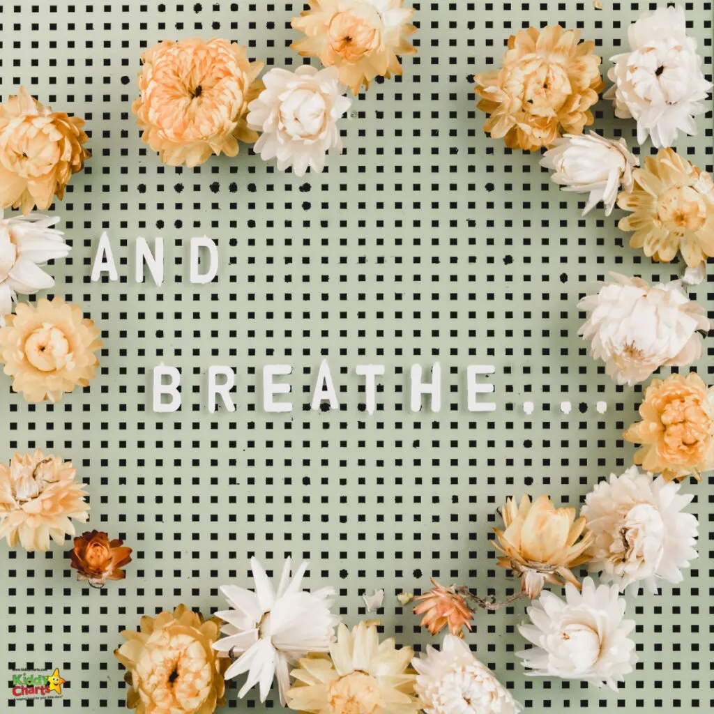 The image features a dotted green background with various white and peach flowers scattered around. The phrase "AND BREATHE" is centrally placed in white.