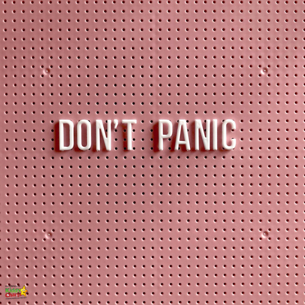 The image displays the phrase "DON'T PANIC" in capital white letters on a pink pegboard background with multiple small round holes. A graphic in the corner suggests an association with "KiddyCharts."