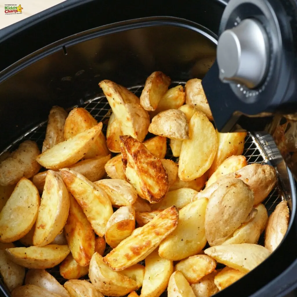 The image shows golden-brown potato wedges inside an air fryer with a visible temperature control knob, indicating a cooking process with less oil.