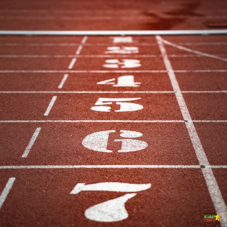 Close-up of a red running track with white lane numbers from one to four, showing competitive sports environment with focus on the texture of the surface.