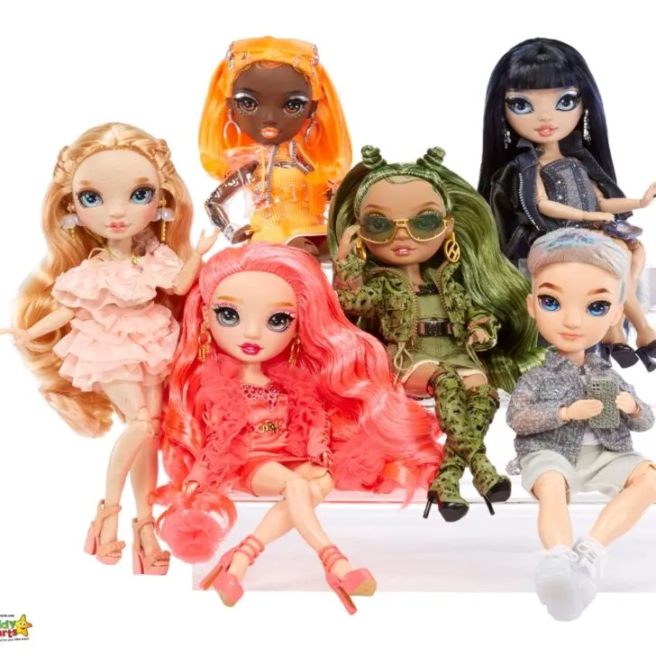 The image features six diverse fashion dolls with unique hairstyles and outfits, posing together against a white background with visible brand watermark.