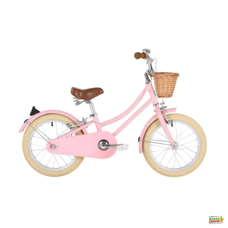 This is an image of a pink children's bike with cream-colored wheels, a brown seat, a wicker basket, and training wheels against a white background.