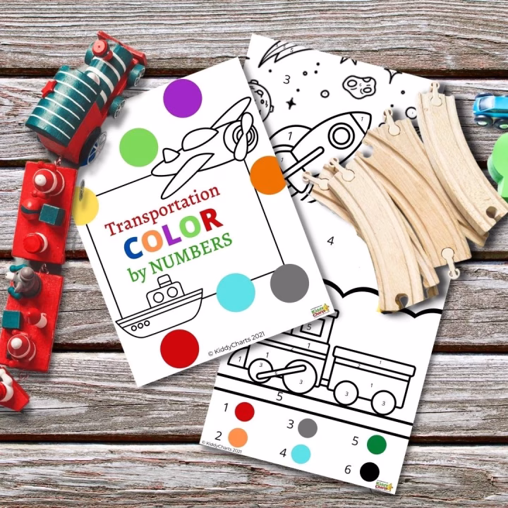Coloring sheets with a "Transportation Color by Numbers" theme rest atop a wood surface, accompanied by colorful wooden toys, suggesting a child's creative play and learning setting.