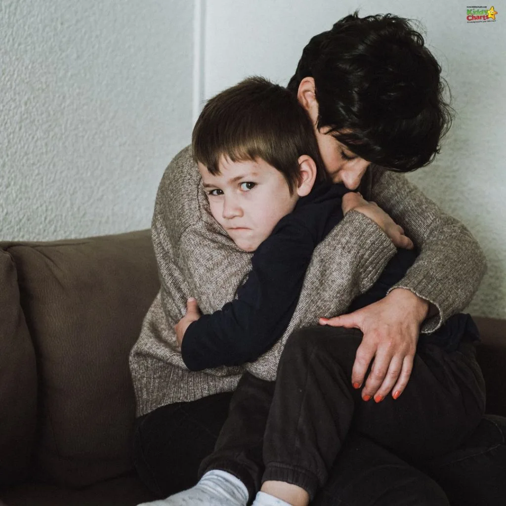 A person embraces a child on a couch in a comforting manner, conveying a sense of support and care in a domestic setting.