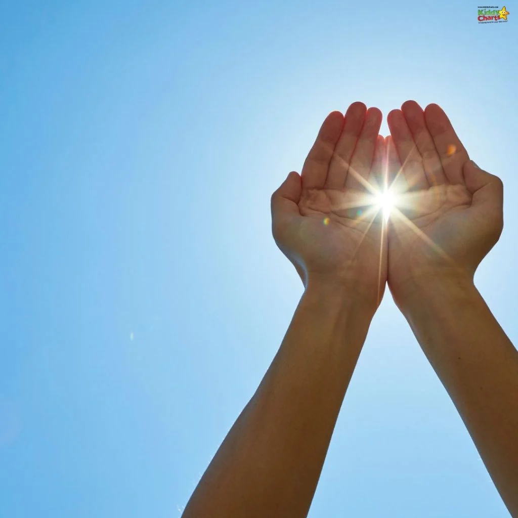 A person holds hands upward, cupping bright sunlight against a clear blue sky, capturing the sun's rays, symbolizing hope and illumination.