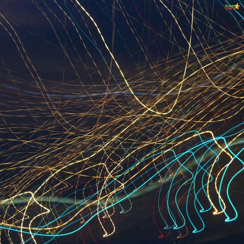 A dynamic display of colorful light trails against a dark background, creating an abstract and energetic visual experience.