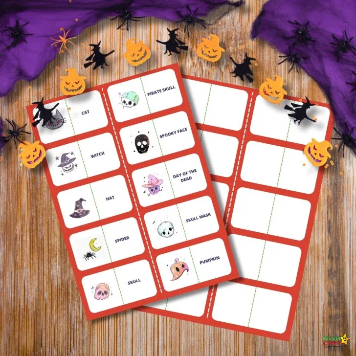 Halloween-themed bingo cards with various spooky illustrations, including cats, skulls, and witches. Decorated with small pumpkin and witch cutouts.