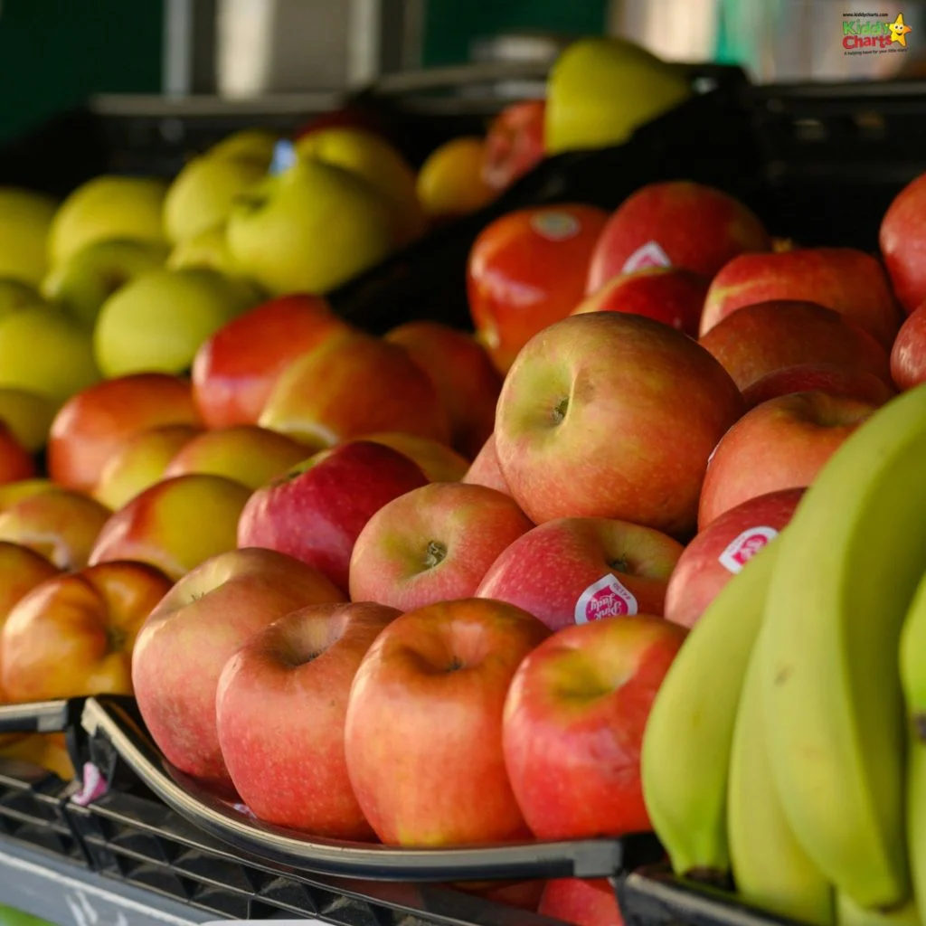 A colorful assortment of red apples, green apples, and ripe bananas on display in a fruit market, showcasing fresh produce.