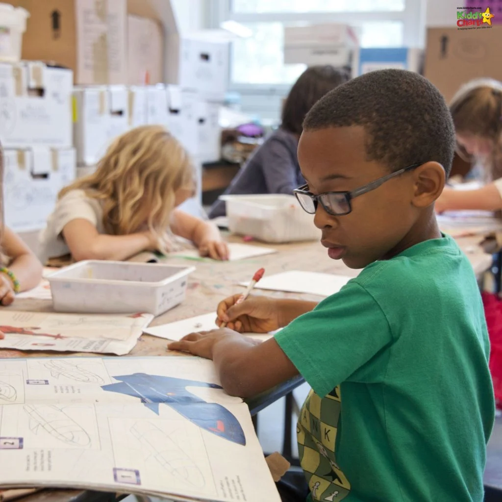 Children engaged in a classroom activity, drawing and reading at tables, focused and creative, with colorful materials and educational worksheets.