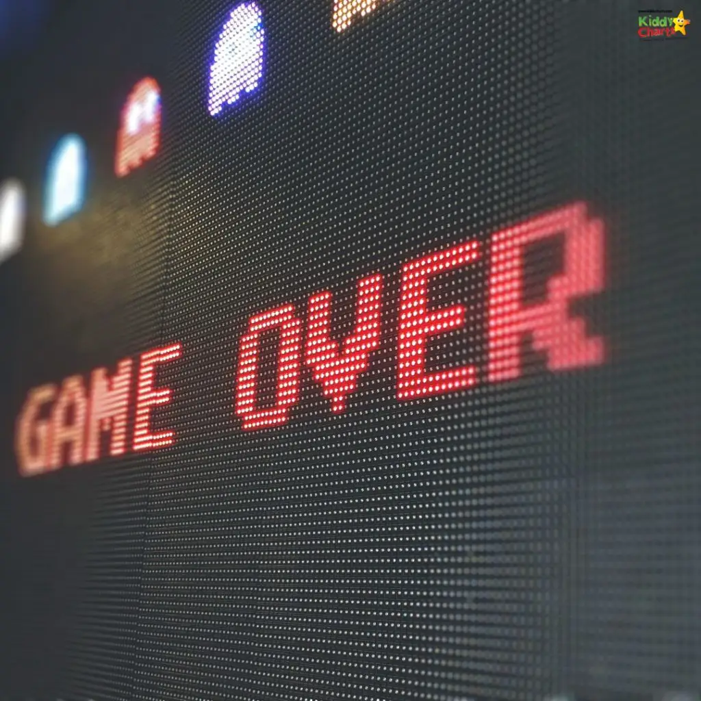 Large LED display shows "GAME OVER" in red text with pixelated graphics of classic arcade game characters in the background.