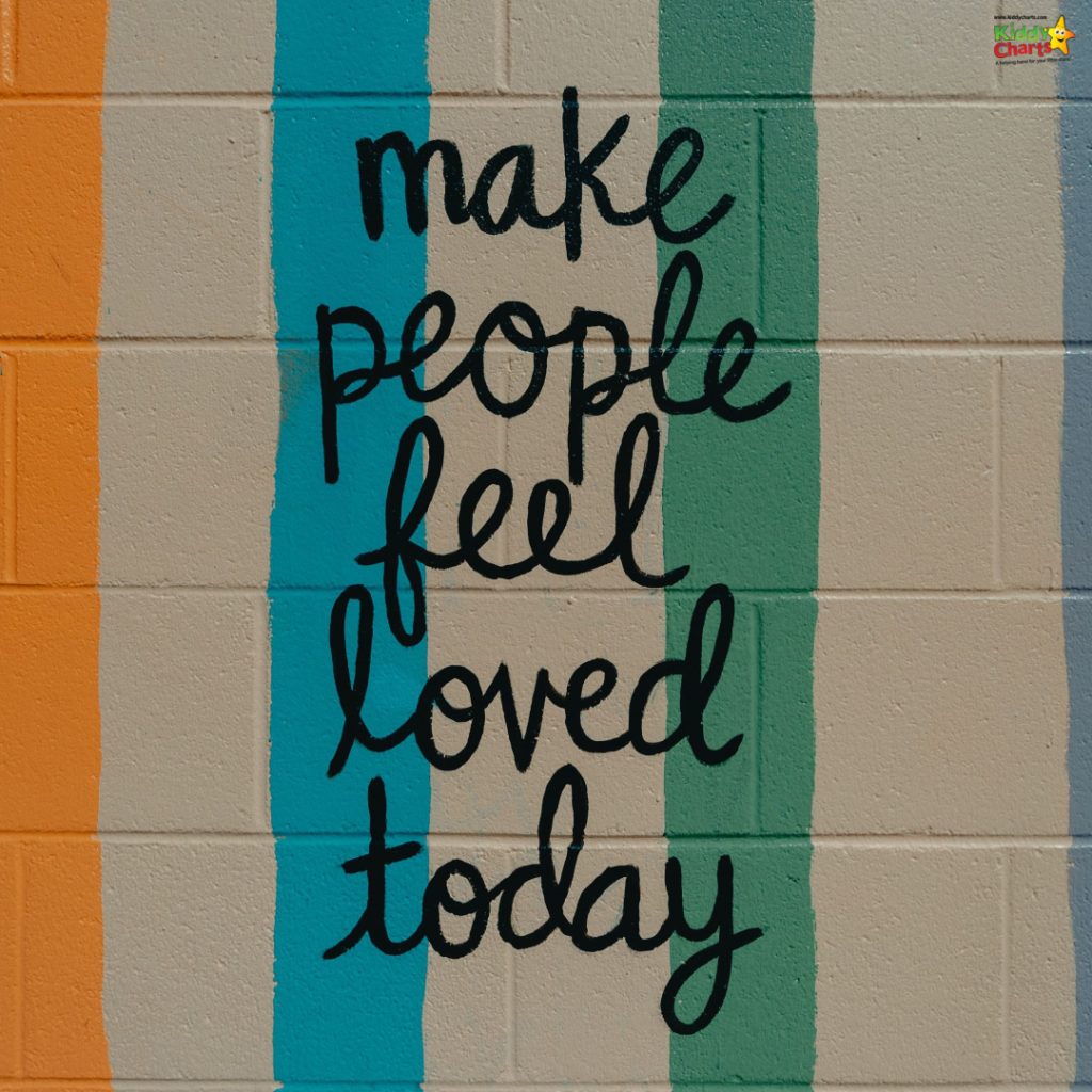 Inspirational graffiti with colorful stripes reads, "make people feel loved today." Encourages kindness on a textured wall backdrop.