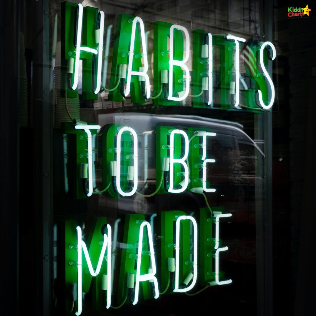 Neon sign with the phrase "HABITS TO BE MADE" in green and white. Reflection of a vehicle partially visible in the background.