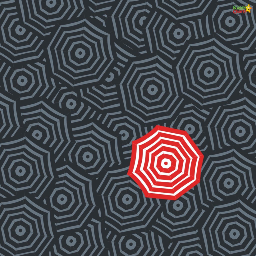 A single red-striped umbrella stands out among many black-striped ones, creating a striking pattern of contrast against a dark background.