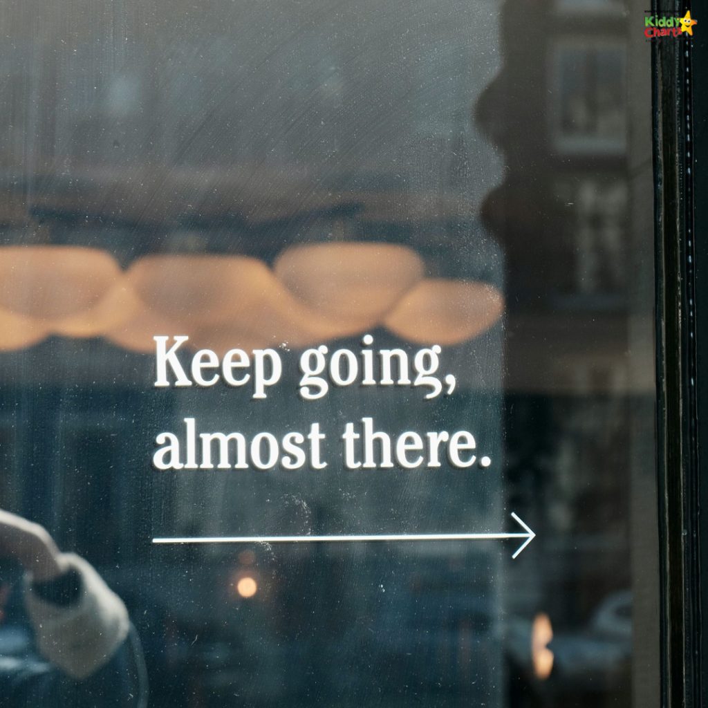Glass window with motivational text, "Keep going, almost there." Reflection shows blurred interior with person and patterned lights. Arrow points right.