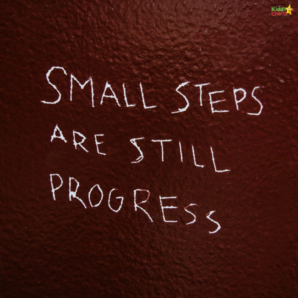 White text reading "Small steps are still progress" on a textured, dark red background with a small, colorful logo at the top corner.
