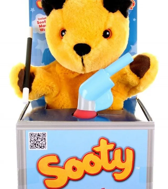 This image shows a limited edition water pistol, a Sooty TM pop-up puppet show, and a Sooty TM mascot costume being included in a package.