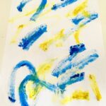 A child is creating a modern artwork with acrylic paints and sketches.