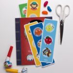A variety of office supplies, including stationery, scissors, and tools, are neatly arranged on a shelf indoors.
