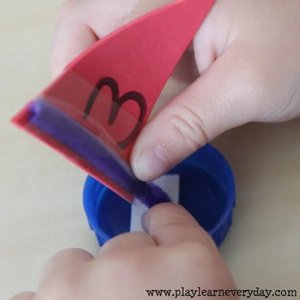 bottle cap sail boats - sticking on sails