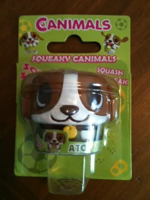 A cartoon toy of LEGO CANIMALS SQUEAKY CANIMALS SO SQUASH FAK ATO indoors.
