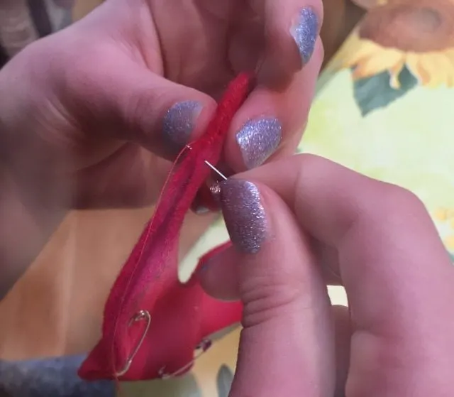 Sewing the candy canes craft - with our glittery Christmas fingers of course!